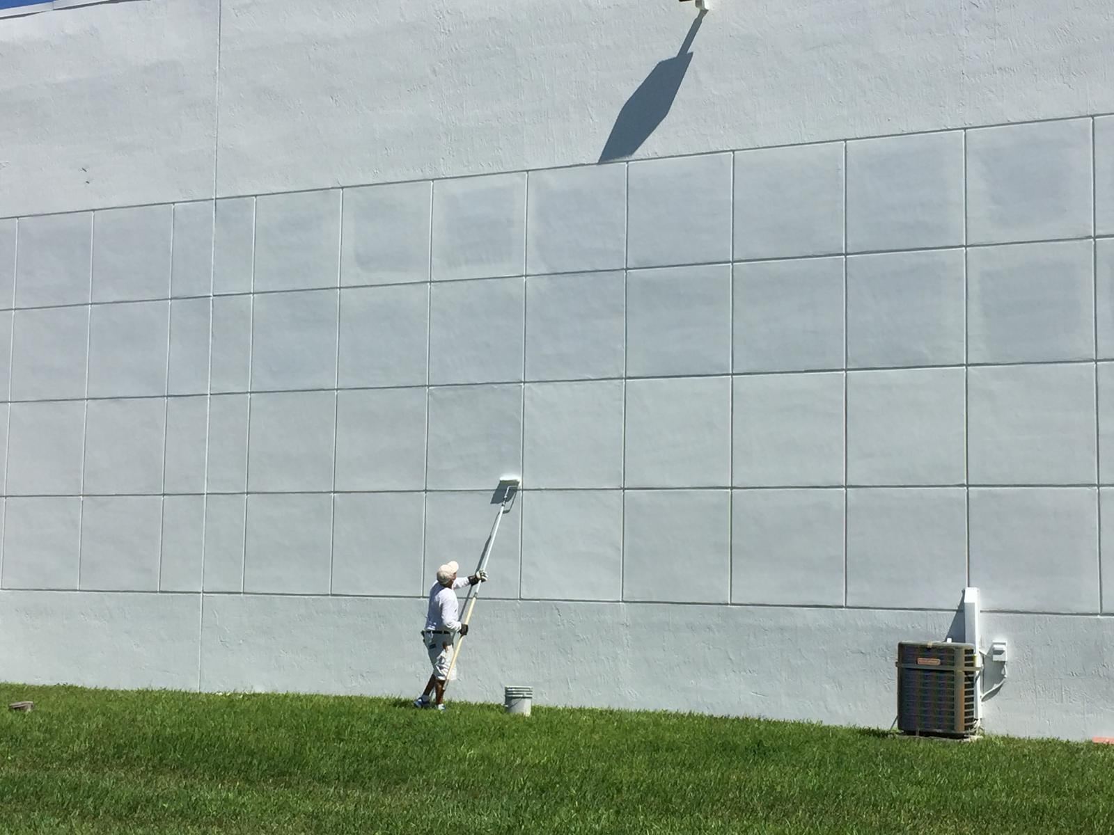 Elite Touch painter rolling a large commercial wall