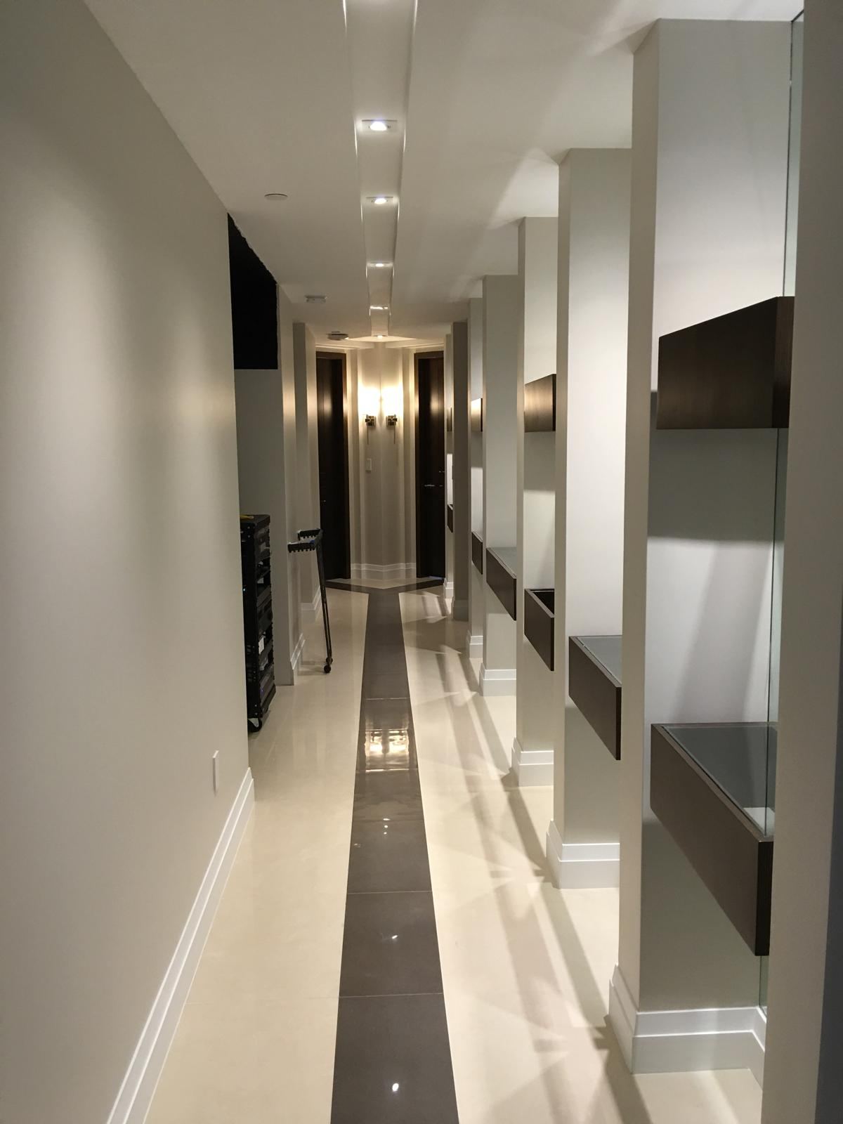 Condo hallway with crisp white baseboards