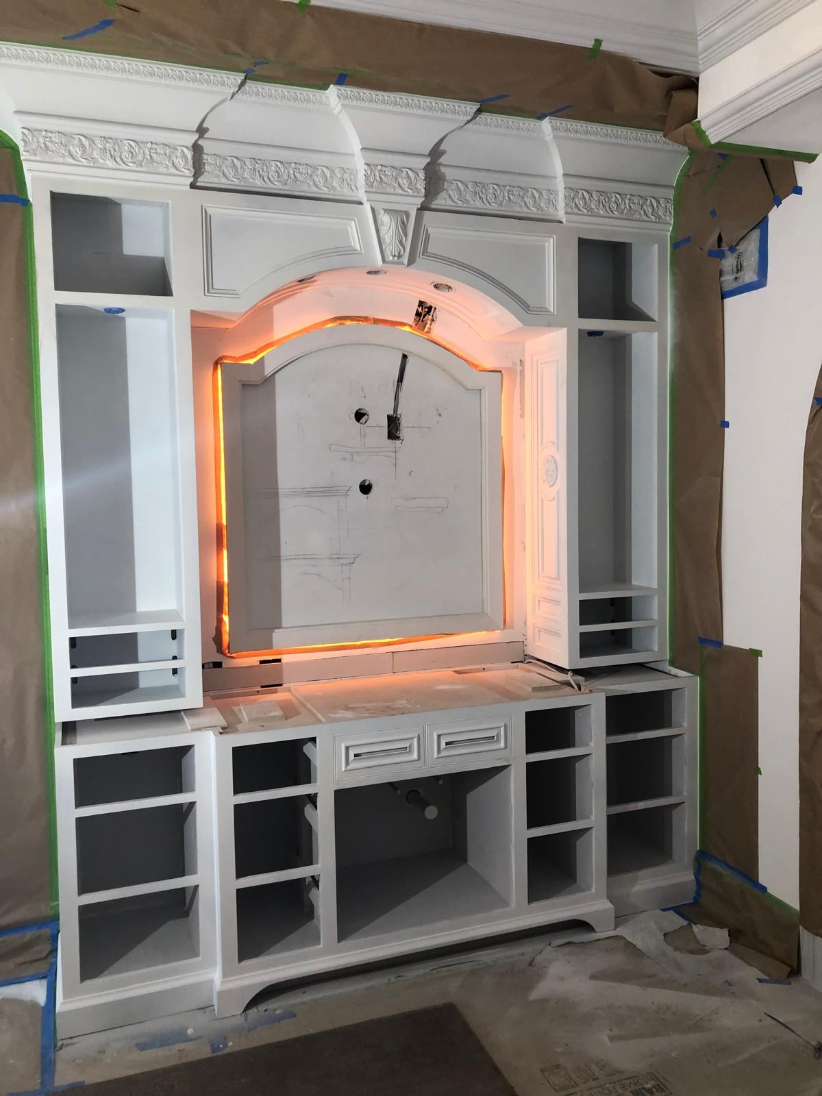 Custom white built-in with carved crown molding