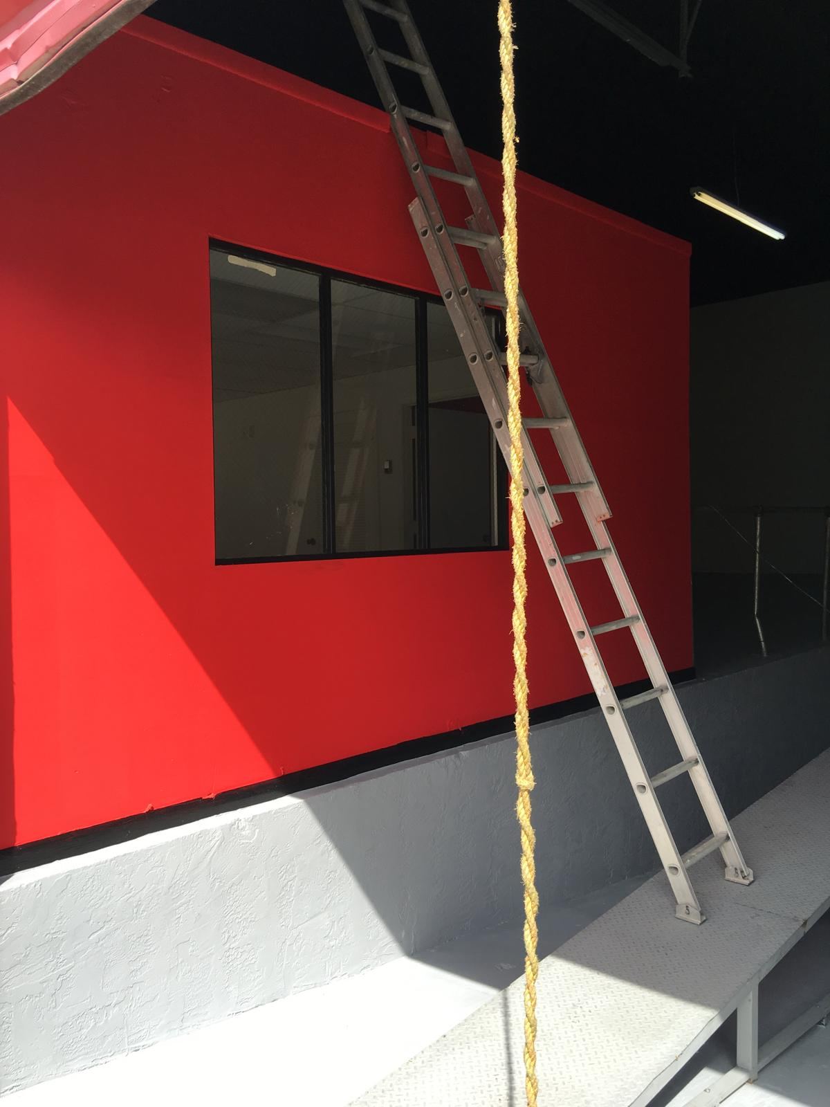 Office wall painted red with black ceiling