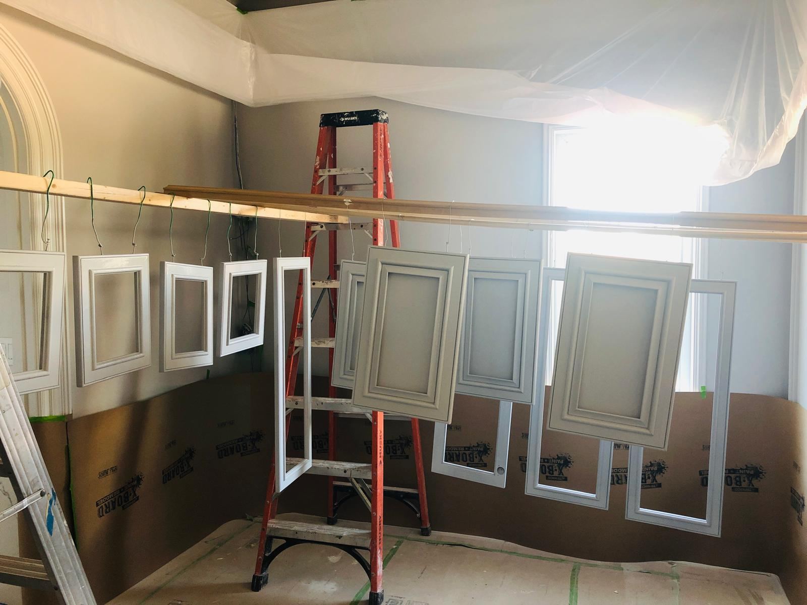 Cabinet doors hung to dry after spraying